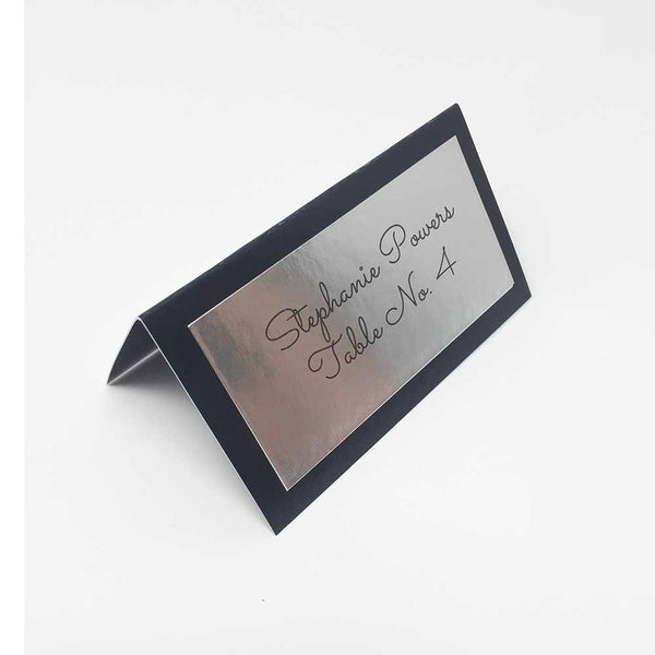 Black place card with silver foil label.